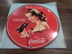 Vintage girl drinking Coca-Cola metal sign